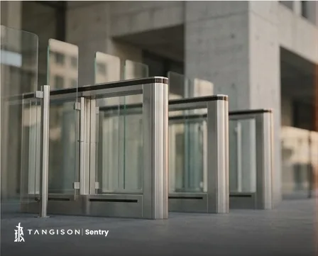 Access control gates at a modern building entrance, the physical checkpoint Sentry logs digitally.